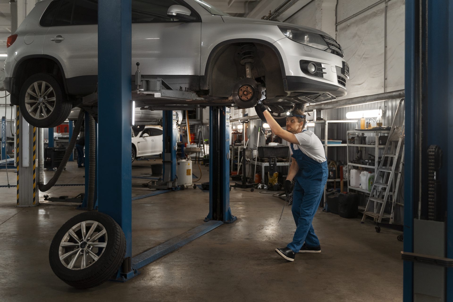 Mechanic inspecting car engine